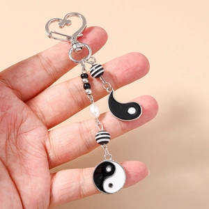 Yin Yang Tai Chi keychain with heart clip, black and white beads, and pearl tassels
