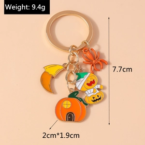 Detailed Halloween keychain view showing pumpkin house and spider charms with 9.4g weight