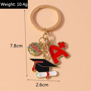 Detail of graduation keychain showing lucky charm, graduation cap, and A plus charm