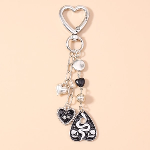 Detail of silver heart keychain with black cherry pendant and rhinestone star charm