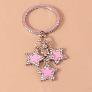 Close-up of silver star keychain with pink enamel inlay and sparkling rhinestone accents