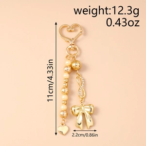 Detail showing dimensions of gold heart keychain with bow and infinity charm on bead chain