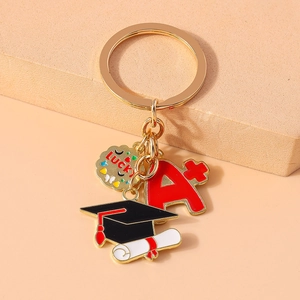 Detailed macro of graduation keychain with A plus charm and black mortarboard pendant
