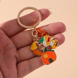 Halloween keychain with pumpkin house, mummy pumpkin, and spider charms on gold ring