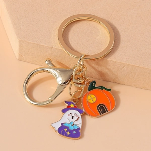 Detail of Halloween keychain with enamel ghost wizard and pumpkin charms on golden ring