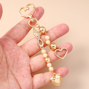 Fashionable gold heart keychain with faux pearls, infinity charm and diamond rhinestones