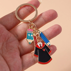 Golden keychain with cartoon pencils and school graduation robe charms for bags