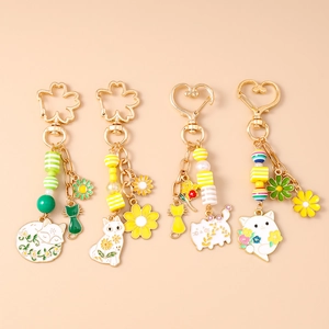 Niedliches Schlüsselanhänger-Set aus Goldmetall mit Cartoon-Katze und Blumenanhänger