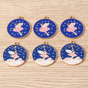 Detailed view of fairy pendants with stars and moon on light wood background