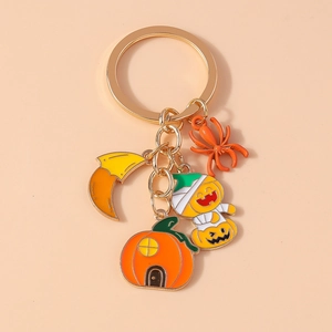 Detail of Halloween keychain featuring ghost, pumpkin, and spider charms on golden ring