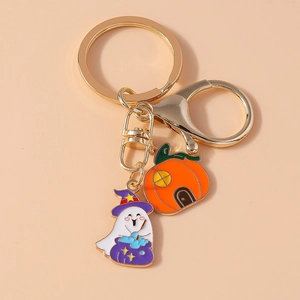 Detail of Halloween ghost with wizard hat and orange pumpkin house enamel key ring