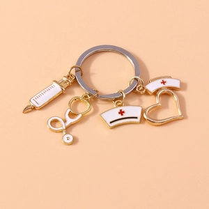 Nurse themed gold metal keychain with heart stethoscope syringe and cap charms
