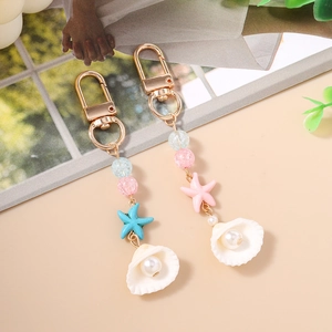 Fashionable ocean-themed keychain with sea stars and shells in macaron colors