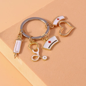 Golden medical keychain with syringe stethoscope and heart nurse hat pendants