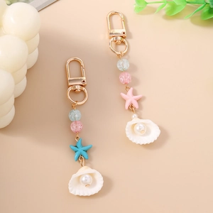 Chic ocean themed beaded keychain with colorful starfish and white shell charms