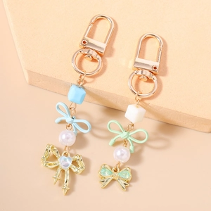 Porte-clés élégants en perles avec nœuds pastel et fermoirs mousquetons dorés chic