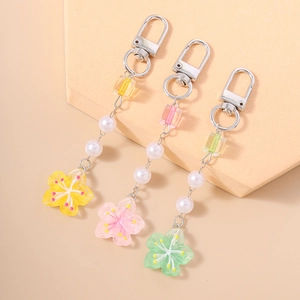 Floral beaded keychain with acrylic flower charms and pearls in yellow pink and green