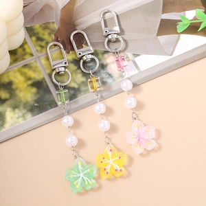 Three-piece set of beaded floral keychains with translucent resin cherry blossoms