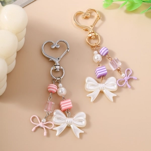 Fashionable beaded bag pendants with striped beads and pearl bows in pink and purple colors