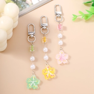 Beaded flower keychains in mint green, yellow, and pink with pearls and resin charms