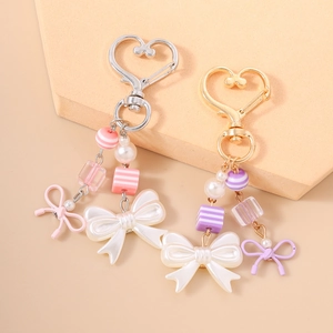 Fashionable heart-shaped keychain set with pearls, striped beads, and cute white bows