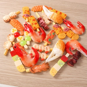Detailed macro view of assorted resin 3D food charms including shrimp and crab for DIY crafts