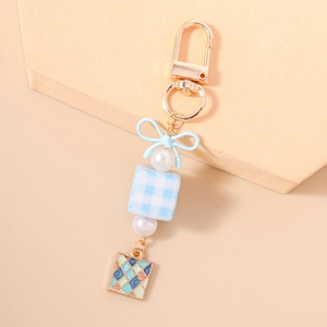 Detailed view of the blue checkered bead and resin bow on this elegant keychain