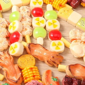 Macro detail of realistic resin BBQ food charms including squid and corn skewers