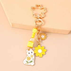 Detailansicht Schlüsselanhänger Katze mit Gänseblümchen und Kirschblüten-Haken in Gelb