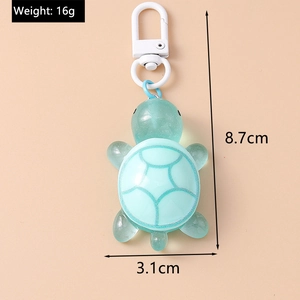 Detail view of mint green resin turtle keychain with size and weight specifications