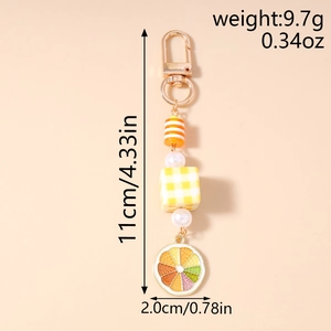 Detail view of pearl beaded keychain with orange stripes and citrus slice charm