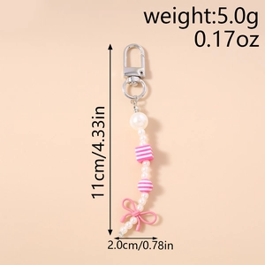 Detail view of pearl beaded keychain with pink bow showing 11cm length dimensions