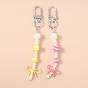 Pink and yellow beaded pearl keychains with striped beads and bow charms for bags
