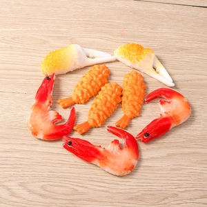 Realistic resin seafood set with miniature shrimp and crab claws on a wooden background