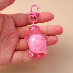 Detailed macro shot of a pink 3D turtle keychain with translucent resin shell