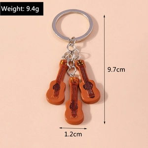 Guitar keychain dimensions showing weight 9.4g and length 9.7cm on pink background