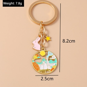Detailed size view of golden rabbit enamel keychain with moon and star pendants