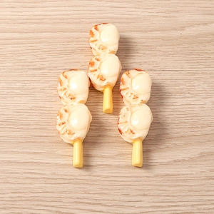 Detailed macro view of realistic resin grilled scallop skewers on wood background
