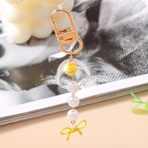 Détail d'un porte-clés méduse créatif avec fermoir doré et perles blanches fantaisie