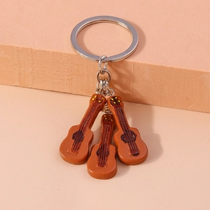 Creative music themed keychain with brown guitar pendants on a silver metal ring