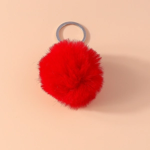 Close-up of fluffy red 8cm faux fur pompom keychain with a polished silver metal ring