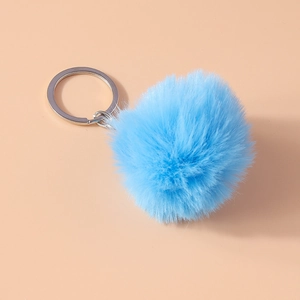 Detailed close-up of a soft sky blue faux fur pompom keychain with silver metal ring