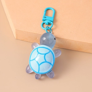 Detailed view of the blue and purple turtle keychain with a transparent resin finish