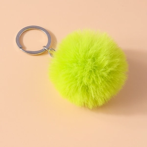 Detail of neon green 8cm faux fur pompom keychain with durable silver metal ring