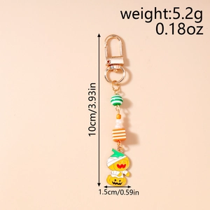 Detail view of Halloween keychain with striped beads and mummy pumpkin enamel pendant