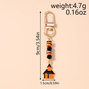 Detail of Halloween beaded keychain with black orange beads and haunted house pendant