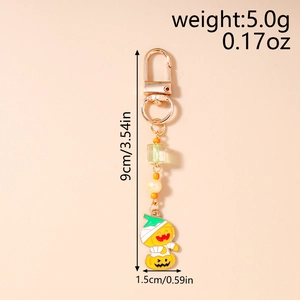 Detail view of Halloween pumpkin mummy keychain with beads and dimensions 9cm by 1.5cm