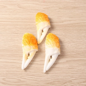 Detailed close-up of realistic resin crab claw models for DIY crafts on wood background