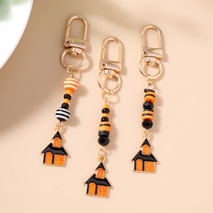 Set of three Halloween beaded keychains featuring black ghost house charms and orange beads