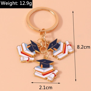 Detail showing graduation theme keychain with gold rings and colorful charm charms